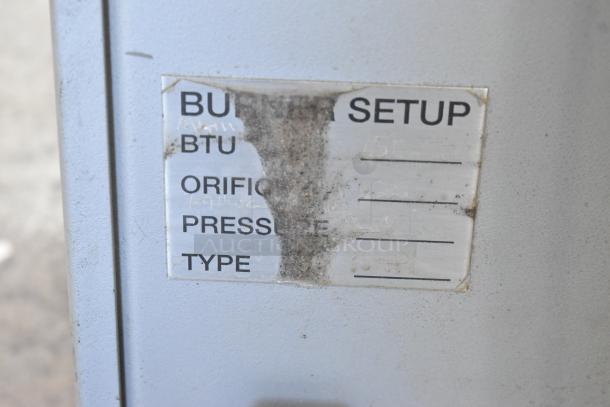 US Roaster Corp metal commercial roaster/smoker, natural gas powered, 208-230/460V, 3 phase. Burner setup label visible.