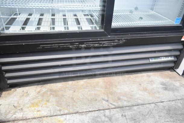 2019 True GDM-41SL-48-HC-LD commercial 2-door cooler with poly-coated racks, visible wear on the exterior, 115V, 1 phase.