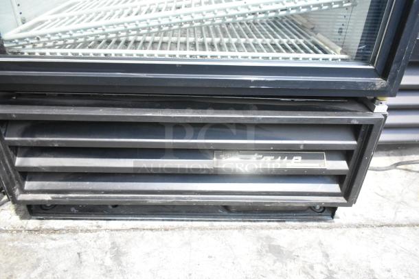True GDM-12 commercial cooler, single door, metal exterior, poly-coated racks, 115V, 1 phase, visible brand marking.
