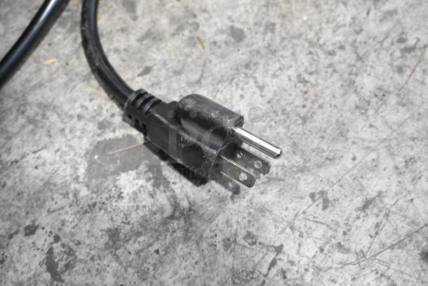 Power plug for 2024 Frigidaire EFR781-B-6COM Reach In Cooler w/ Freezer, 115 Volts, shown on textured surface.