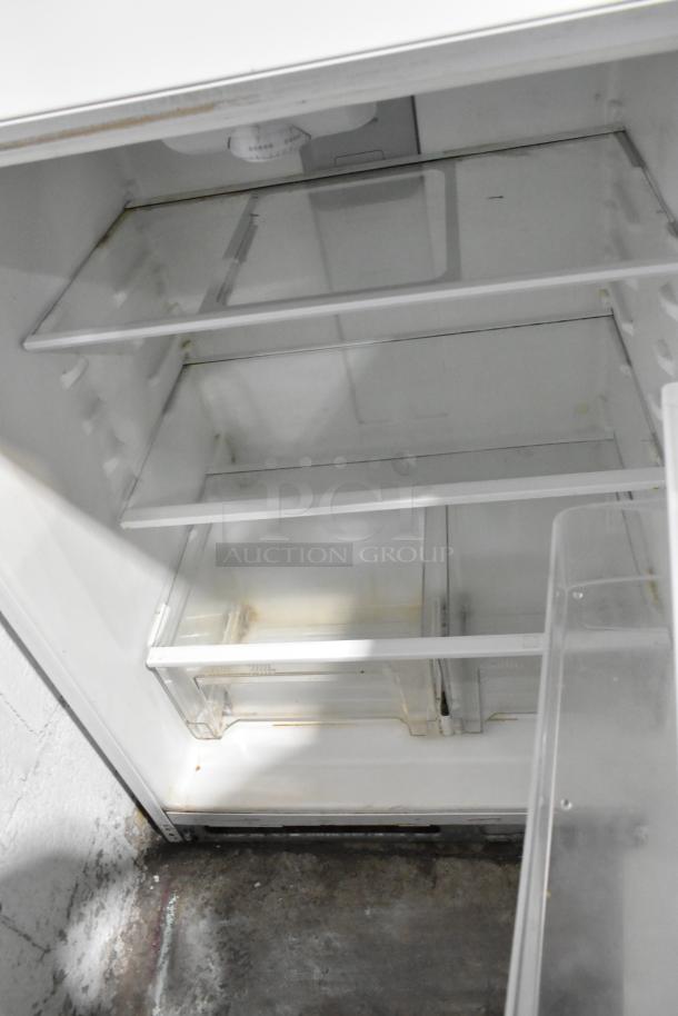 Whirlpool WRT511SZDW00 reach-in cooler and freezer, interior view, 115 volts, 1 phase; visible shelves and dial.