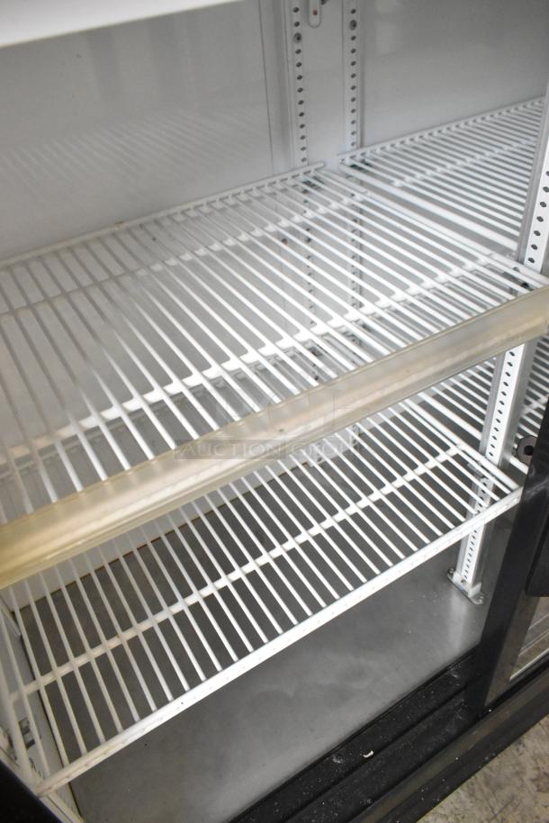 2019 True GDM-41SL-48-HC-LD commercial 2-door cooler with poly-coated racks, white interior, good condition.