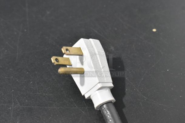Close-up of a three-prong plug for a 2019 True GDM-41SL-48-HC-LD commercial cooler.