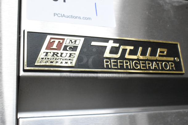 True T-35 stainless steel cooler label, featuring True Refrigeration logo; durable commercial appliance.