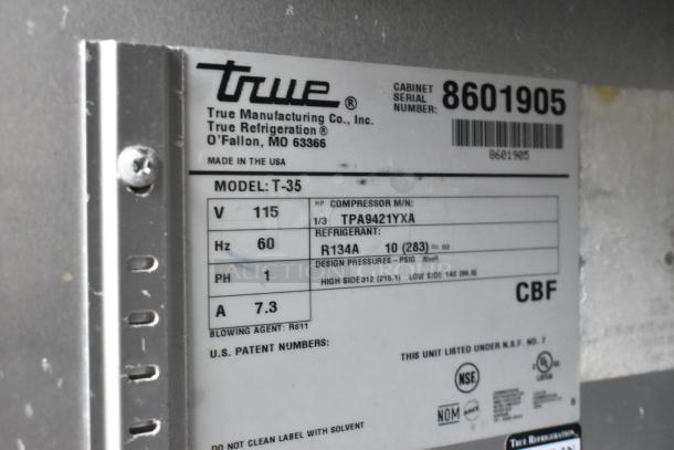 True T-35 commercial cooler label showing voltage 115V, phase 1, and refrigerant R134A. Includes serial number and certifications.