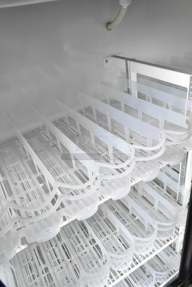 Imbera VRD41 metal commercial cooler interior showing poly-coated racks, clean and well-maintained.