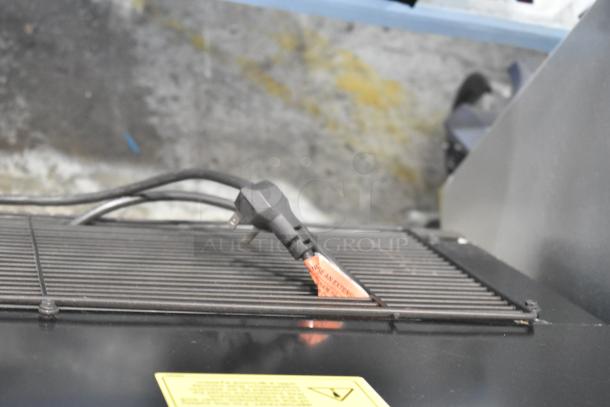 Imbera VRD41 Cooler detail showing 115V power cord on metal grille, highlighting power requirements and sturdy construction.