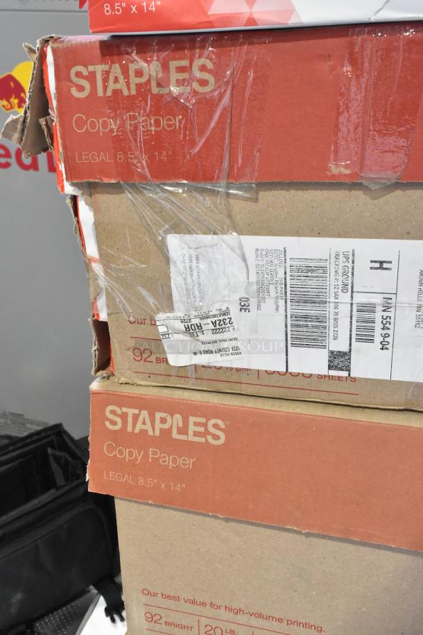 Five boxes of Staples copy paper, legal size 8.5"x14", 92 bright. Includes shipping labels. Slight wear on packaging.