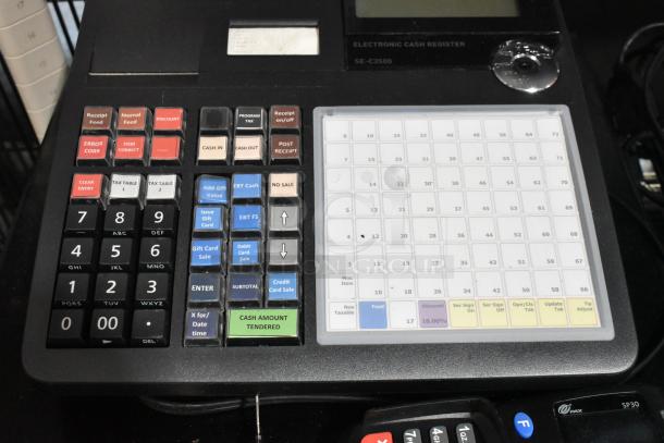 Casio SE-C3500 electronic cash register with keys. Features numeric keypad, function buttons. 120 Volts, 1 Phase.