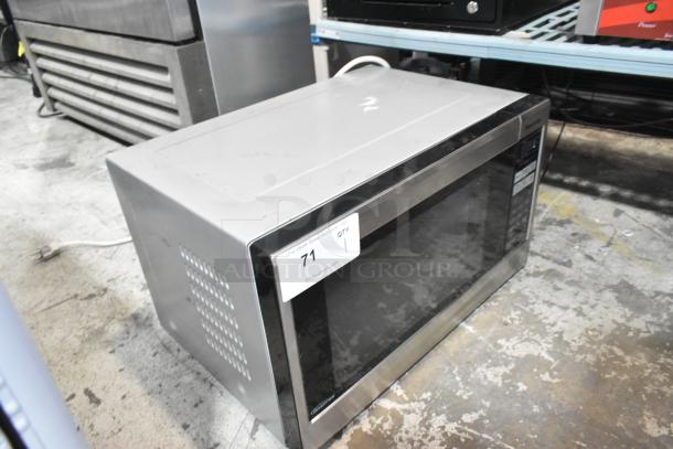 Panasonic NN-SN661S stainless steel countertop microwave oven with plate, 120 volts, 1 phase, visible scratches.