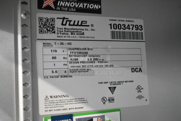 2020 True T-19F-HC stainless steel commercial freezer with poly-coated racks, on casters. 115V, 1 Phase. Model number label shown.