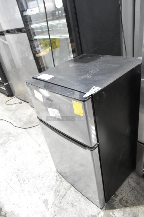 Galanz GLR31TS1E02 mini cooler with freezer, 115V, 1 phase. Stainless finish, minor wear, tags visible indicating model info.