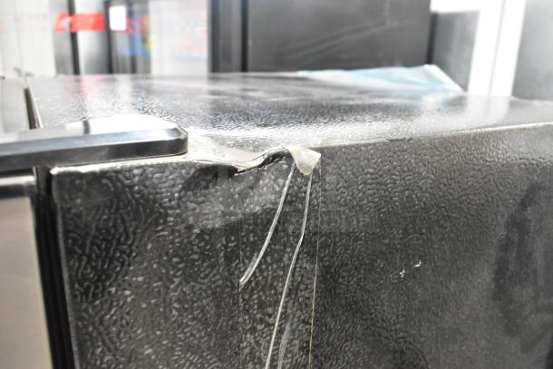 Frigidaire FGFR727 Reach In Cooler w/ Freezer, 115V, 1 Phase, black finish, visible surface damage and tape on edge.