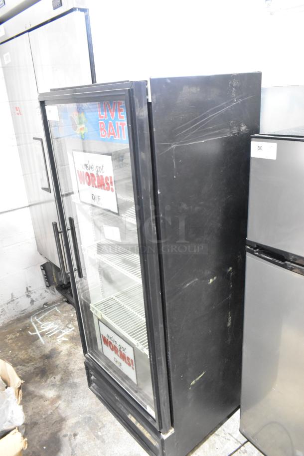 True GDM-12 metal commercial cooler with single glass door, poly-coated racks, and visible exterior scratches, 115V, 1 Phase.