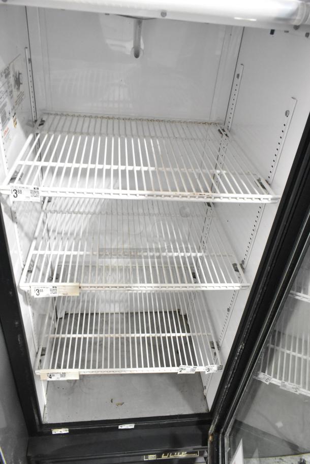 True GDM-12 metal commercial cooler with three poly-coated racks, single glass door, and label markings. 115V, 1 phase.