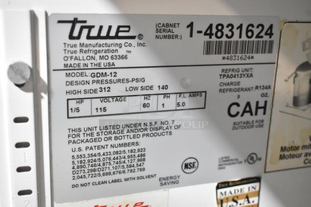 True GDM-12 cooler label, showing model, voltage (115V), phase (1), and serial number, indicating storage/display use.