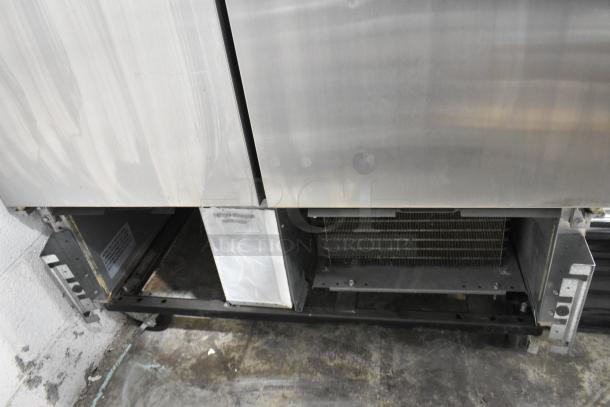 2019 True T-35-HC stainless steel 2-door reach-in cooler; bottom view showing internal components and poly-coated racks.