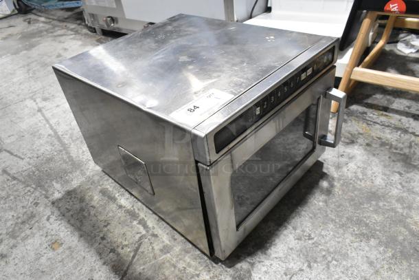 Menumaster MDC182 stainless steel commercial countertop microwave oven, 208/230 volts, 1 phase. Visible wear on exterior.