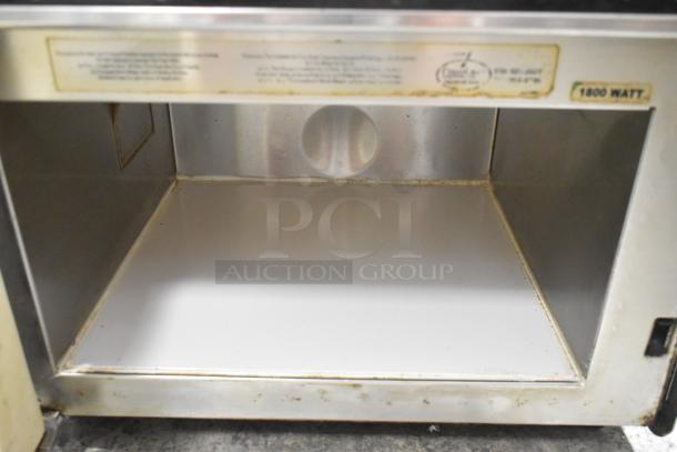 Menumaster MDC182 stainless steel commercial microwave oven, 208/230V, 1 phase, interior view showing wear and label markings.