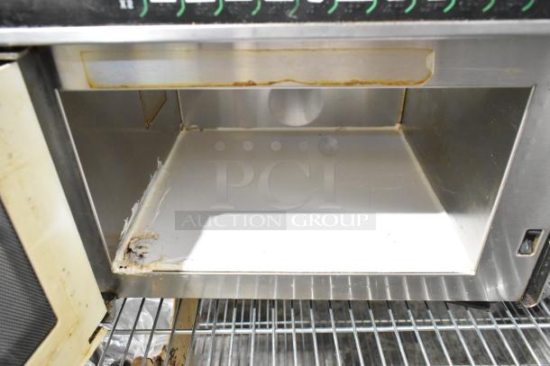 Menumaster MDC182 commercial microwave, stainless steel, visible wear, 208/230 volts, 1 phase, interior detail shown.