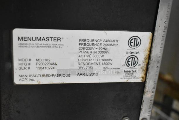 Menumaster MDC182 stainless steel commercial microwave tag; shows model, voltage, frequency, power specifications, and April 2013 manufacture date.
