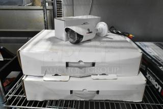 Two boxes of Lorex CVC7711PK4B cameras, new condition, with original packaging. Ideal for enhancing security systems.