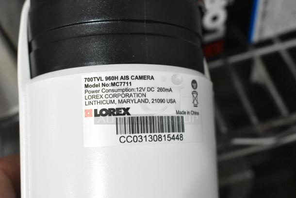 Lorex CVC7711PK4B camera, Model MC7711, 700TVL 960H AIS, 12V DC, visible label details.