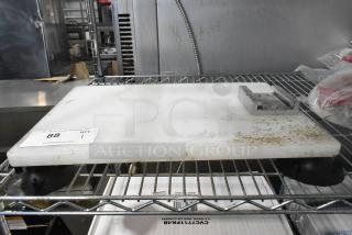 Nemco cutting board mount for vegetable slicer, showing moderate wear, metal bracket attached, auction tag with number 88 visible.