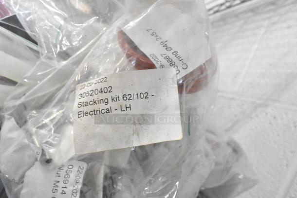 Lot of brand new silicone hoses and stacking kits, labeled "Stacking kit 62/102 - Electrical - LH," dated 22-09-2022.