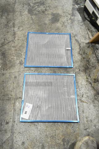 Two metal filters with blue frames on concrete. Slightly used condition. Auction tag indicates lot 90, bid multiplier 2x.