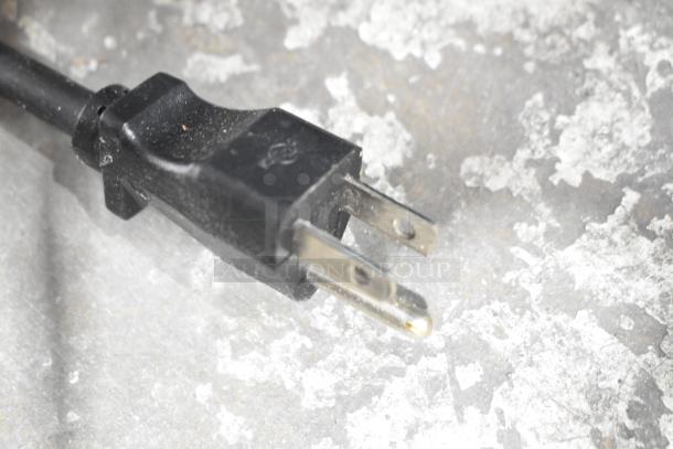 Close-up view of a power plug for the Nemco 7000A-2S Waffle Maker. Visible two-prong design suitable for 120 Volts.