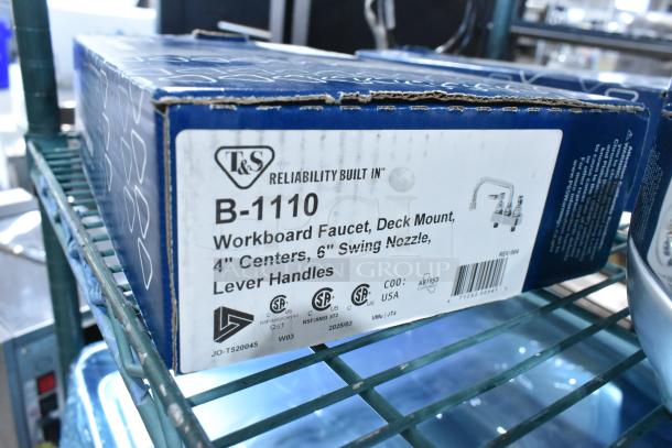Brand new T&S B-1110 deck mounted workboard faucet, 4" centers, 6" swing nozzle; box shows minor scratches and dents.