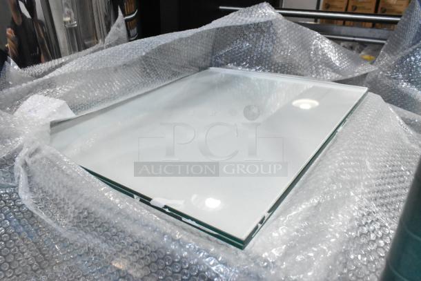 Brand new glass pane, scratch and dent condition, wrapped in bubble wrap, suitable for various applications.