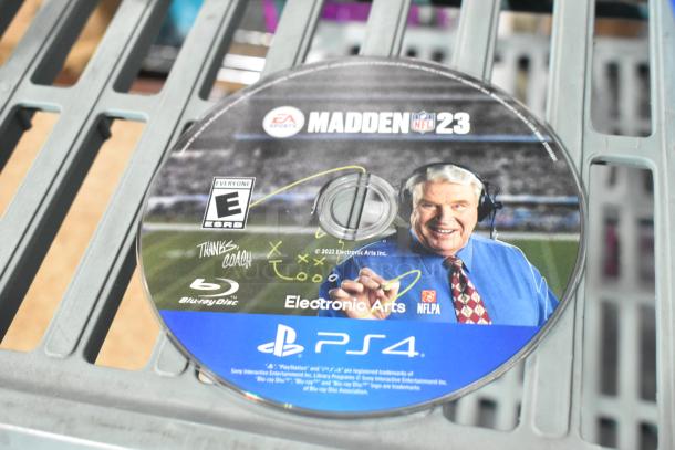 PS4 Madden NFL 23 game disc featuring coach, rated E by EA Sports, Blu-ray format.
