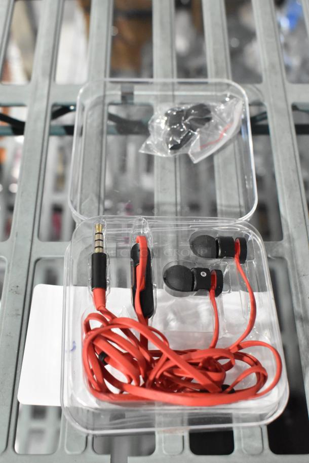 Alt text: PS4 NBA 2K19 game, headphones, PlayStation controller, red earphones in packaging.