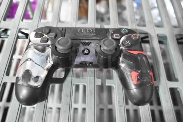 Custom PlayStation controller with Star Wars Jedi Fallen Order graphics. Some wear visible on buttons and grips. 