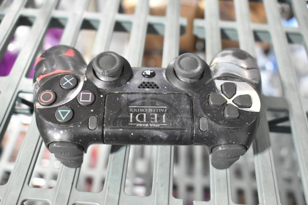 PlayStation Controller with "Jedi: Fallen Order" design, black with galaxy pattern, showing slight wear.