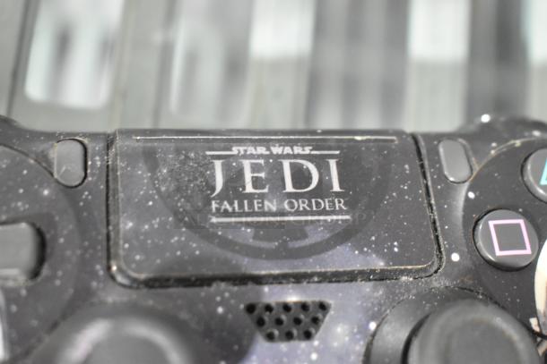 PlayStation controller with "Star Wars Jedi: Fallen Order" design, indicating themed appearance, minor wear visible.