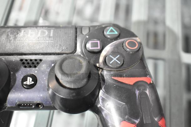 Close-up of a customized PlayStation controller with a Jedi: Fallen Order design. Controller in used condition.
