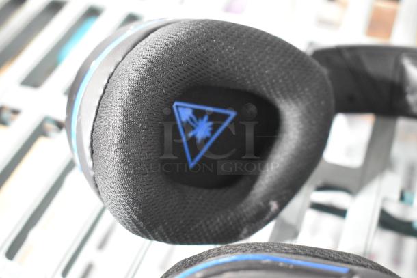 Headphone with black cushioned ear pad displaying a Turtle Beach logo.