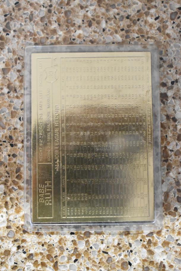 Gold Babe Ruth card featuring detailed major league records, encased in protective cover, excellent condition.
