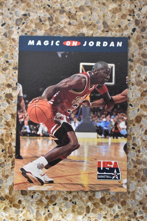 Michael Jordan basketball card titled "Magic on Jordan," showing Jordan in action, wearing a red Bulls uniform on a court.