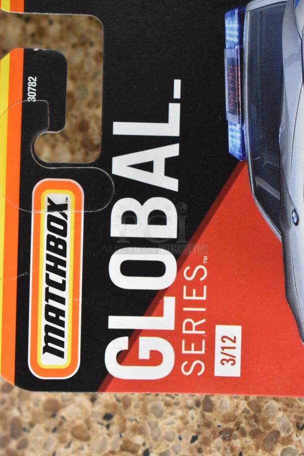 Matchbox Global Series packaging, 3/12, vibrant red and black design, part of a six-item auction lot.