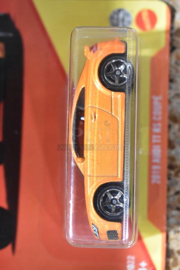 Orange Matchbox car in original packaging, displayed sideways. MIB condition with visible logo on packaging.