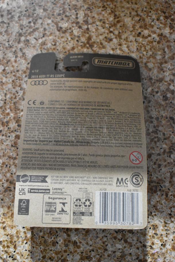 Back of Matchbox 2019 Audi TT RS Coupe packaging with safety information and barcodes, made in Thailand.