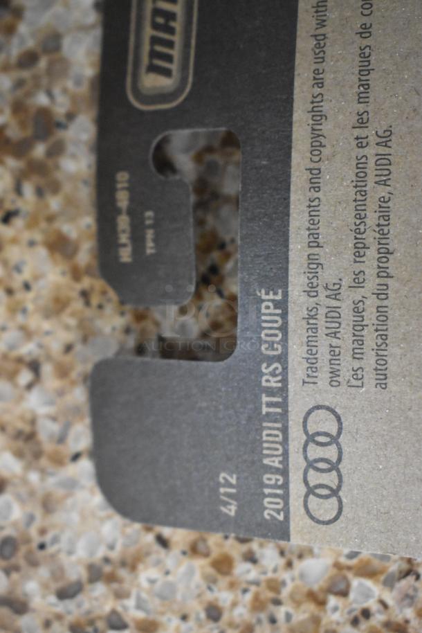 Close-up of a Matchbox label indicating "2019 Audi TT RS Coupe," part of a collectible series, showing branding details.