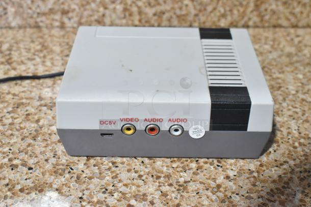 Coolbaby RS-41 game console in gray, showing ports for DC5V, video, and audio, with QC PASS sticker visible.