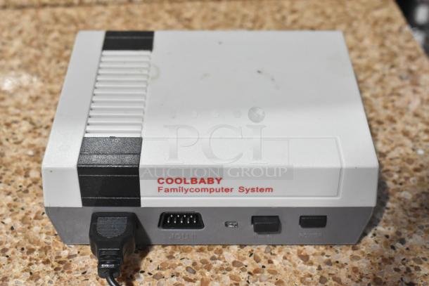 Coolbaby RS-41 game console, white with black accents, labeled "Familycomputer System," moderate wear, ports visible.