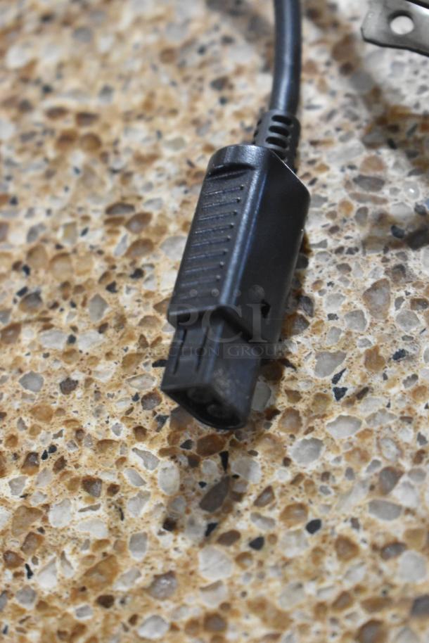 Close-up of a black connector cable on a speckled surface, part of a lot including Coolbaby RS-41 and Nintendo DS items.