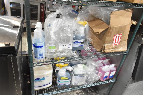 Two-tier shelf with Diversey Wiwax, restroom cleaner, Scott Foam cleanser in original containers, some boxed, visible labels.